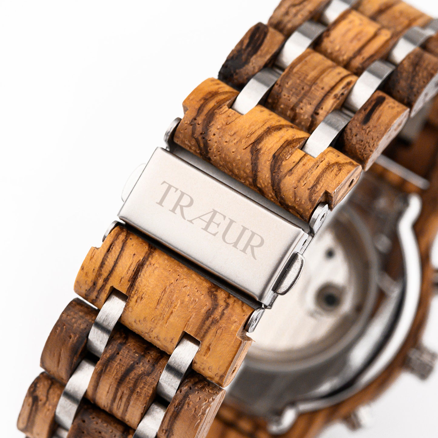 Close-up of wooden and stainless steel watch band with TRÆUR engraved clasp