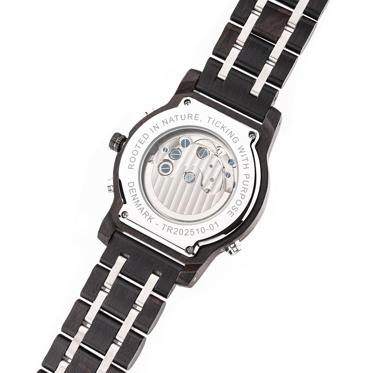 Back case of TRÆUR mechanical wooden watch revealing the visible movement, showcasing gears and intricate craftsmanship within the ebony wood and stainless-steel frame.