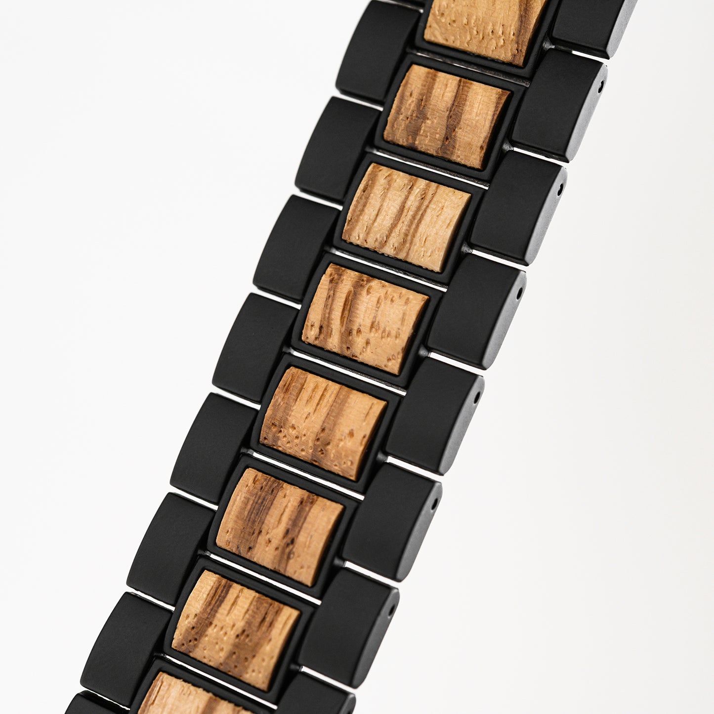 Close-up of black and natural wood link bracelet with textured wooden inserts