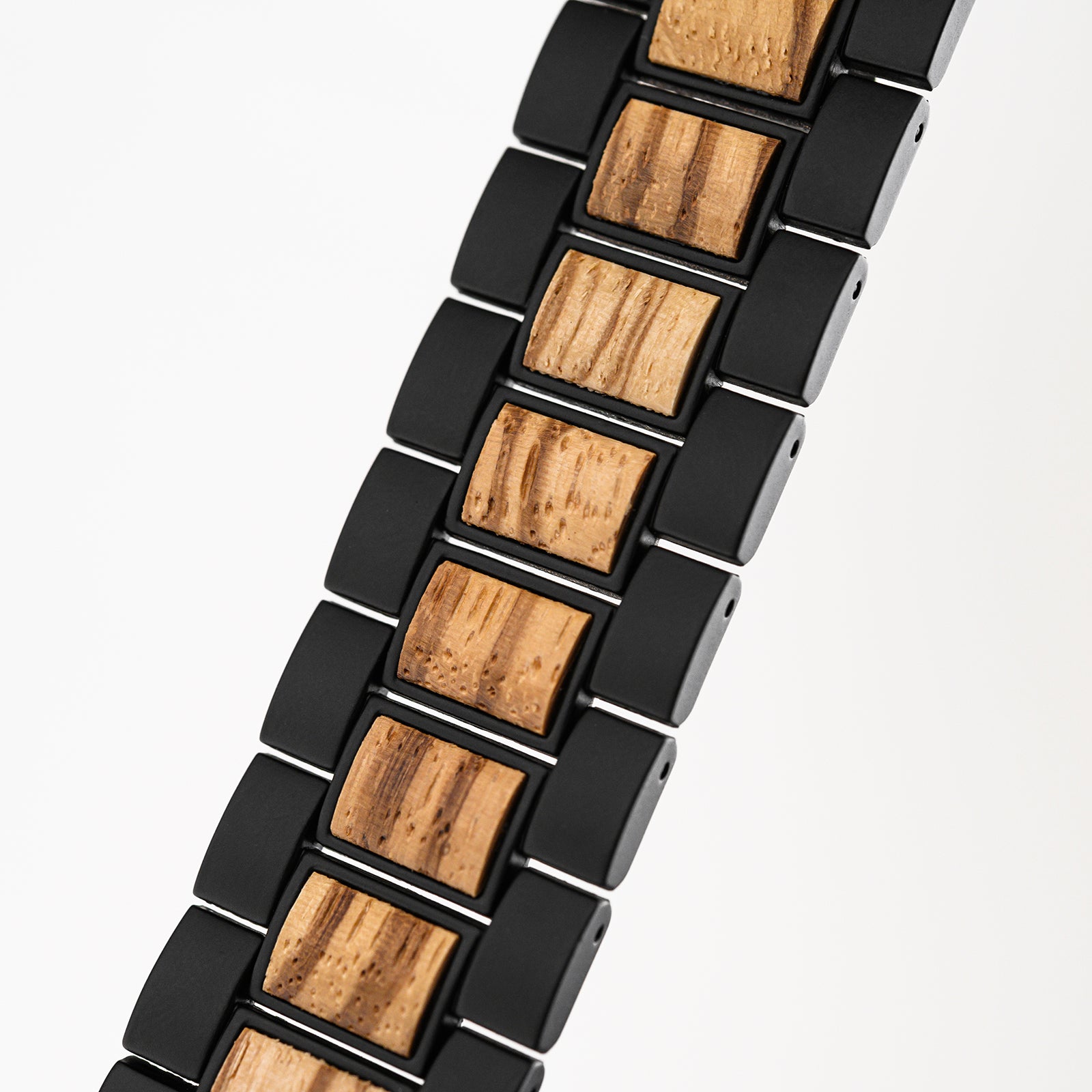 Close-up of black and natural wood link bracelet with textured wooden inserts
