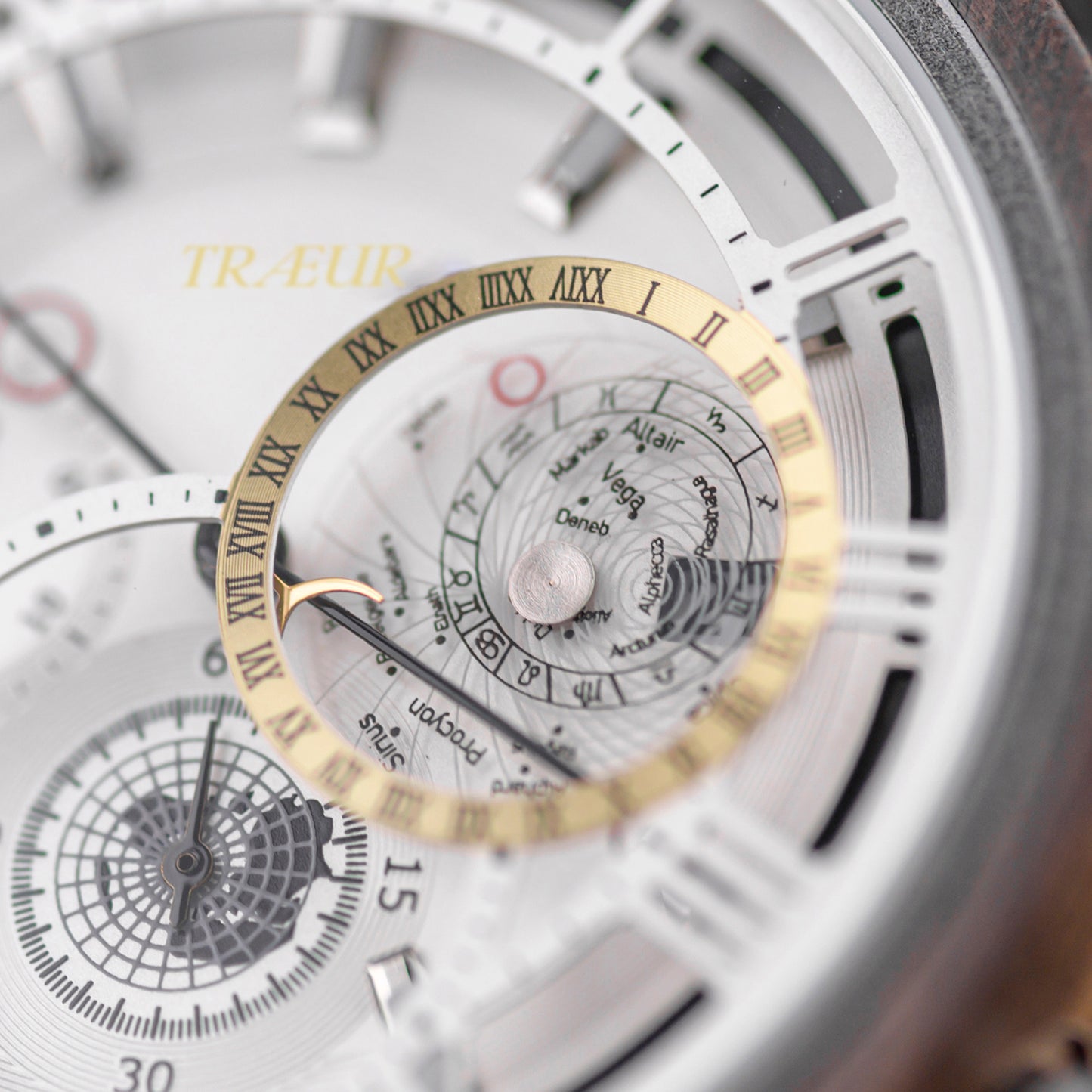 Close-up of a luxury watch dial with a gold Roman numeral ring and star constellation details