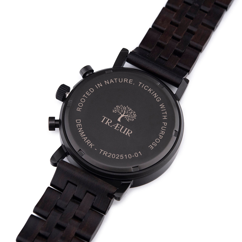 Back of black wooden wristwatch with engraved tree logo and text on white background